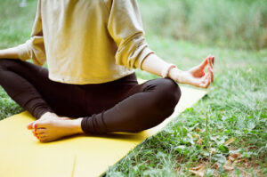 Person practicing yoga for stress management in Alameda, CA