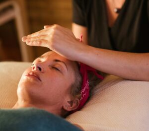 Woman receiving a Reiki massage at Bespoke Wellness Alameda to support relaxation, mental clarity, and brain health.